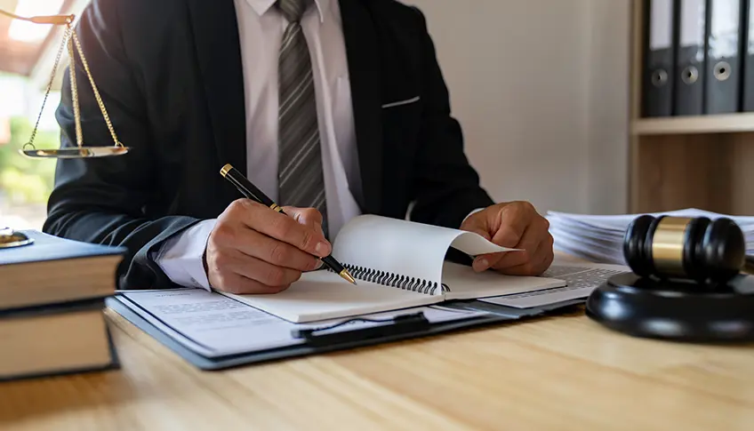 Attorney reviewing a medical record timeline and case documents at a desk